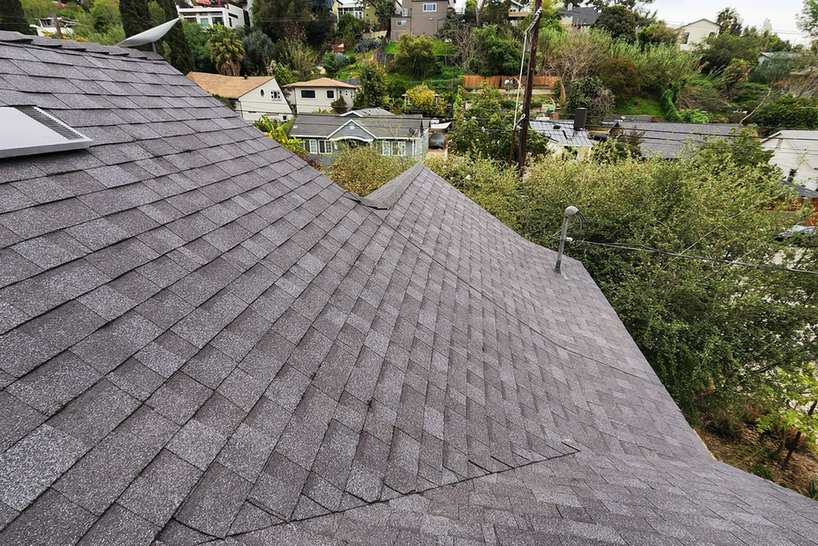 Roof-level photograph showing gray shingles meeting along finished hips and valleys.