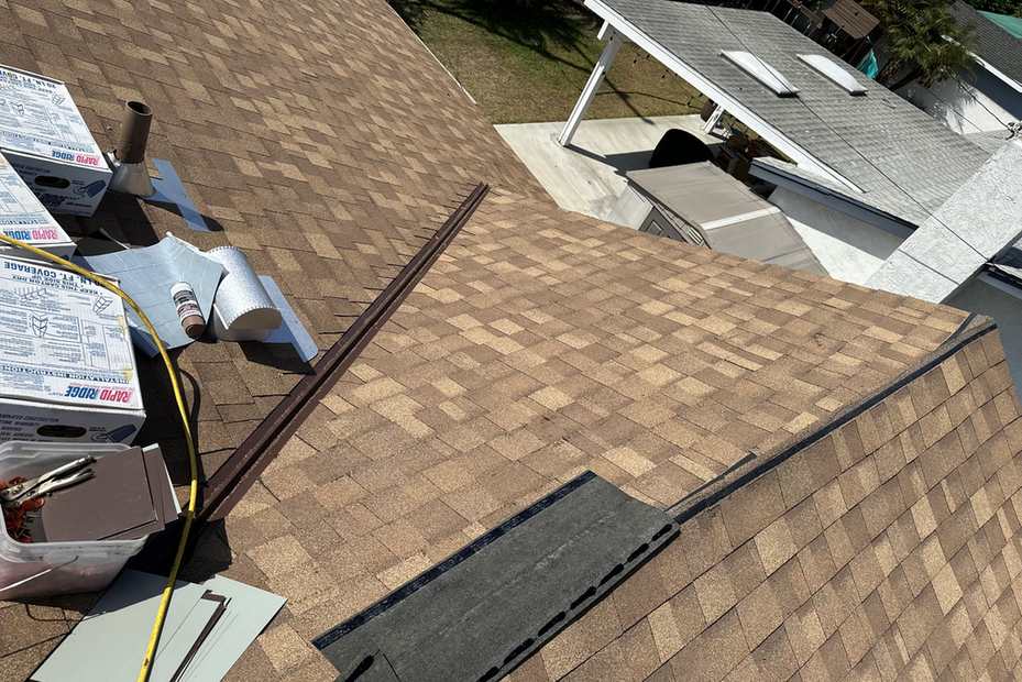Roof-level photograph showing multitone shingles across an installation area.