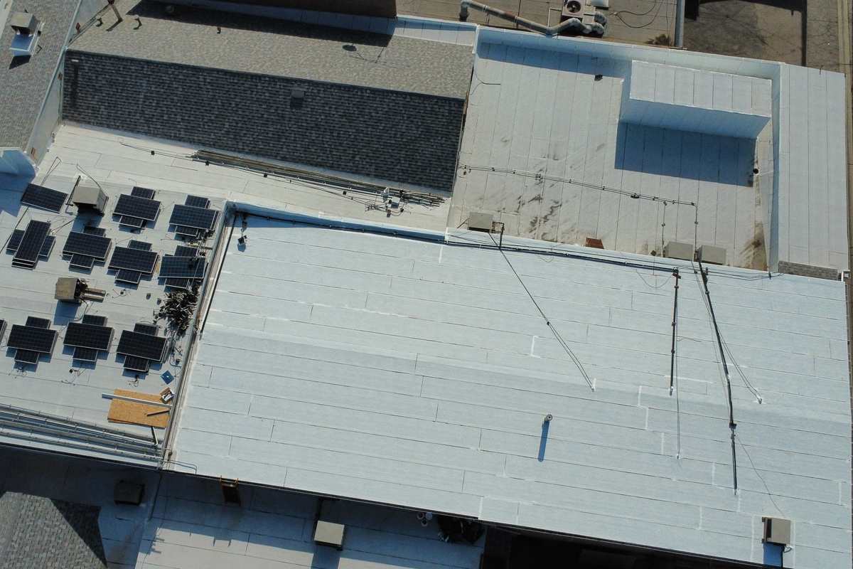 Daylight view of a commercial low-slope roof viewed from above.